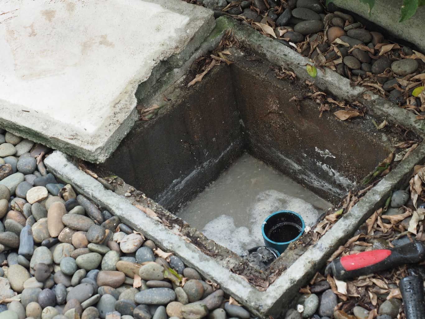 drain-cleaning-plumber-repairing-clogged-grease-trap-with-auger