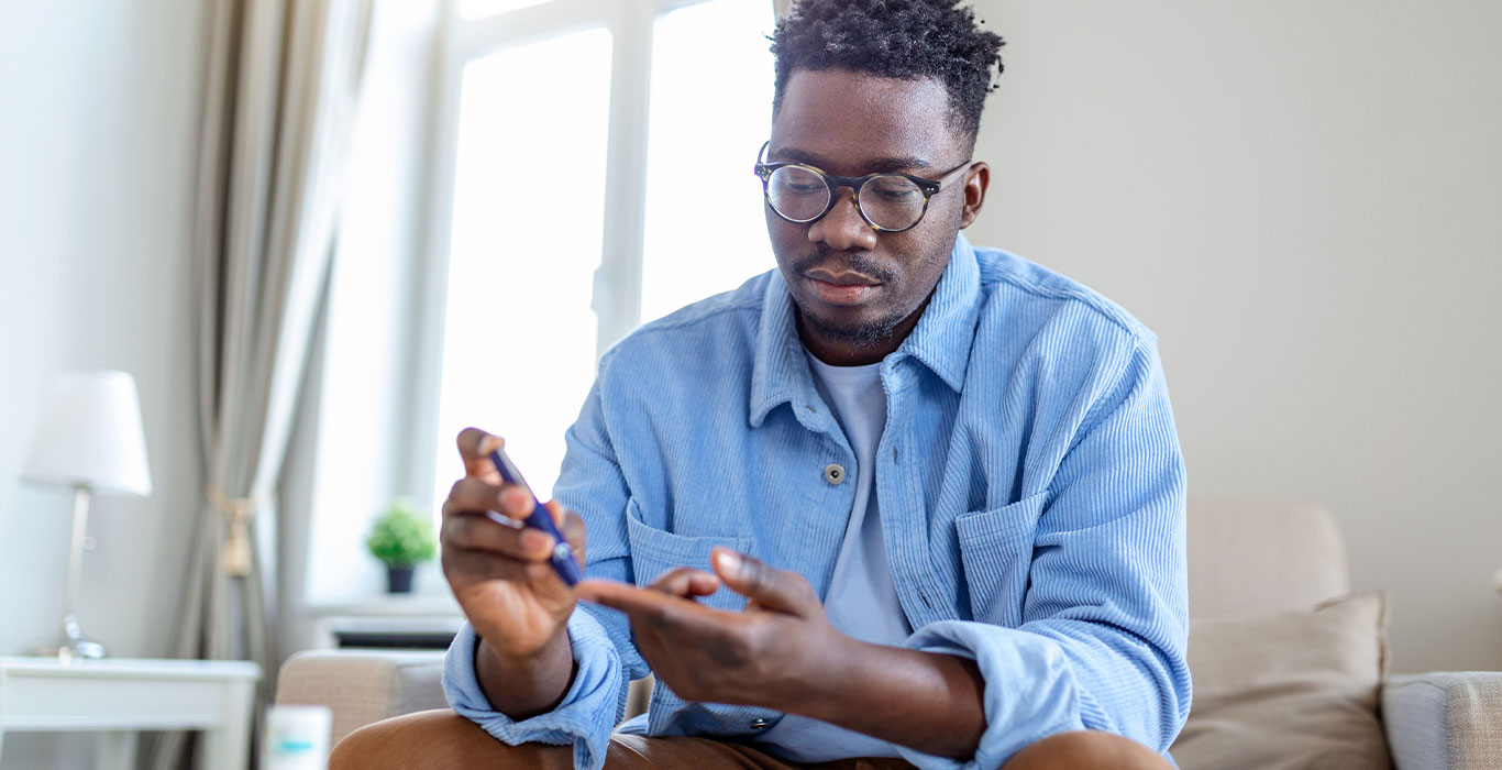 Black Man checking his blood sugar level